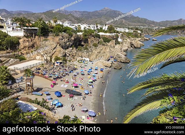 Calahonda beach crowded with bathers seen from the Balcon de Europa. Nerja, Costa del Sol, Malaga Province, Andalusia, southern Spain