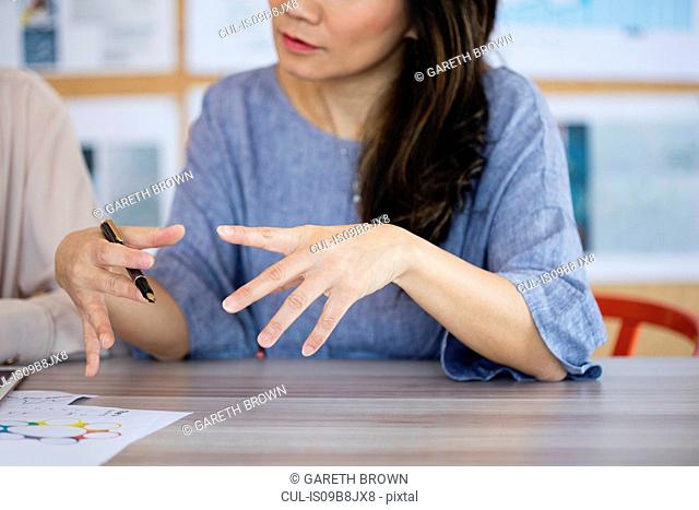 Woman explaining concept with animated hand gestures