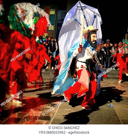 A man wearing a bearded mask, holding a sword and riding a toy horse dances during the annual pilgrimage to the Our Lady of Guadalupe Basilica in Mexico City