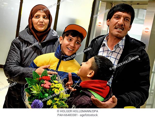 Afghan refugee boy Mahdi Rabani (2.f.L) stands next to his mother Shockria, his father Ibrahim and his brother Yussuf (L-F) in the arrivals hall of the...