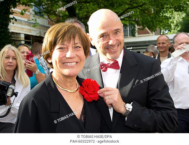 Former professional ski racers Rosi Mittermaier and Christian Neureuther smile during the break during the opening of the 104th Bayreuth Festival in Bayreuth