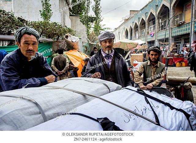 Portrait of street vendors in traditional Afghan cloth on Bazaar in Old city of Kabul, Afghanistan