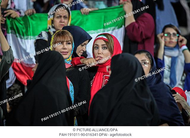 10 October 2019, Iran, Tehran: Iranian women attend the FIFA soccer World Cup qualification match between Iran and Cambodia at the Azadi Stadium