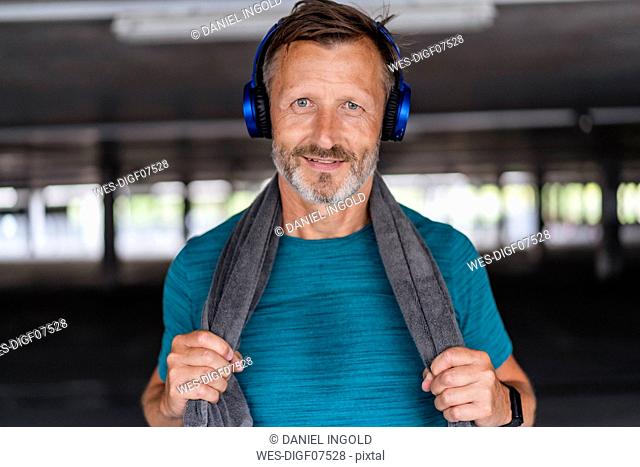 Portrait of a sporty man wearing headphones after workout