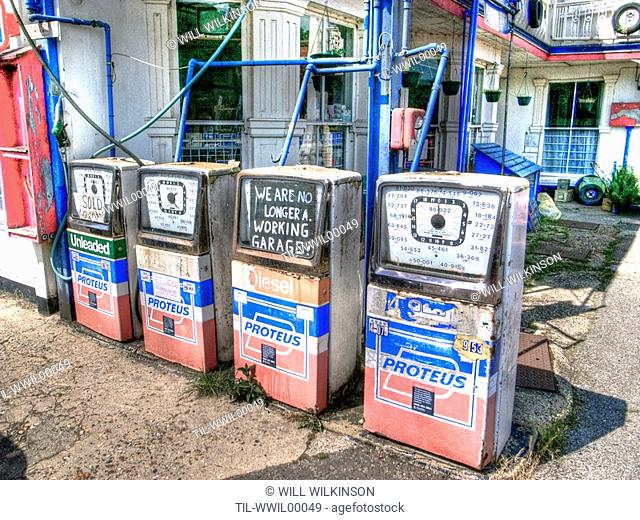 Old petrol pumps in a garage forecourt