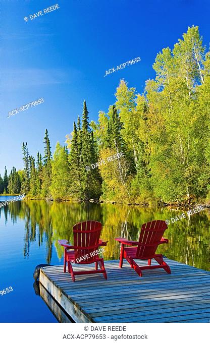 Adirondack?chairs on dock, MacKay Lake, northern Saskatchewan, Canada