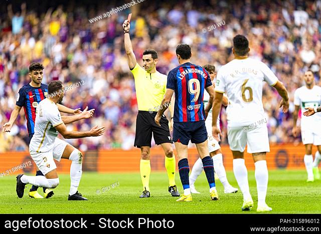 Referee Munuz Ruiz shows a red card to Gonzalo Verdu (Elche CF) (L) during La Liga football match between FC Barcelona and Elche CF