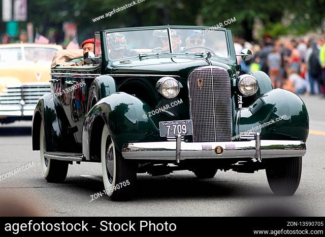 Washington, D.C., USA - May 28, 2018: The National Memorial Day Parade, a cadillac classic car, carry military veteran down constitution avenue