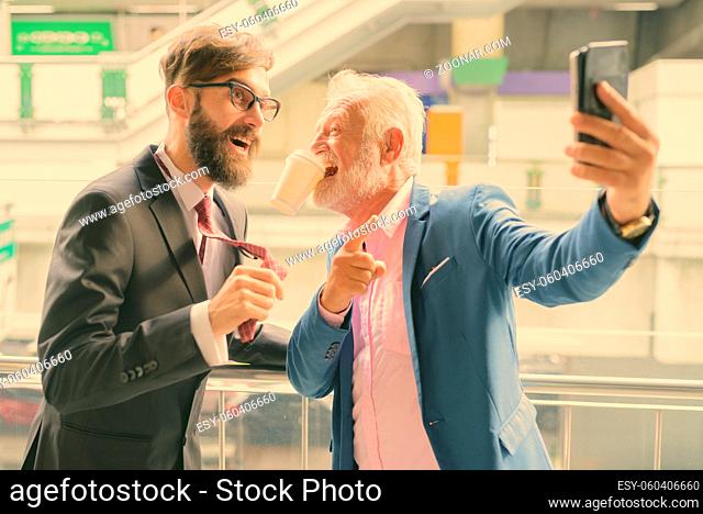 Portrait of two multi ethnic bearded businessmen together around the city of Bangkok