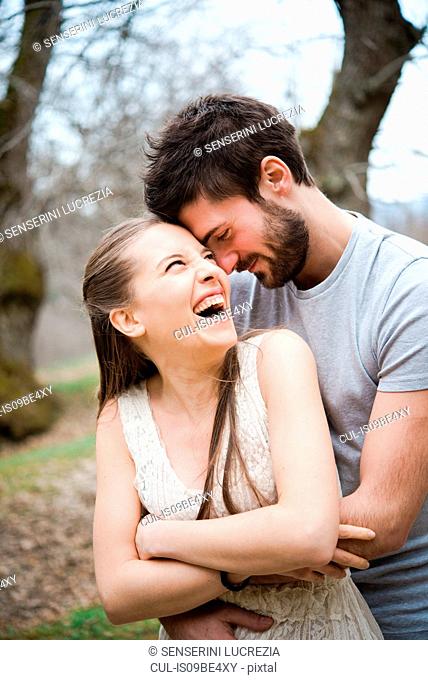 Couple hugging in park