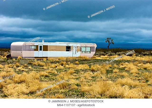 Desolate and abandoned mobile home trailer in the southern California desert