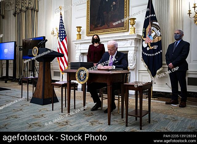 U.S. President Joe Biden signs an executive order after speaking during an event on his administration's Covid-19 response with U.S