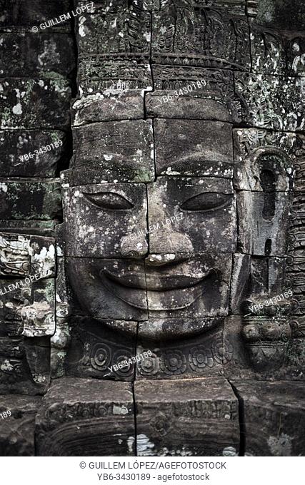 Stone carved Buddha head in Bayon at the Angkor Thom temple in Angkor Wat, Siem Reap, Cambodia