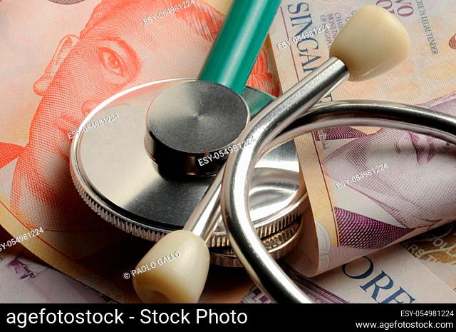 Various Singapore banknotes with stethoscope