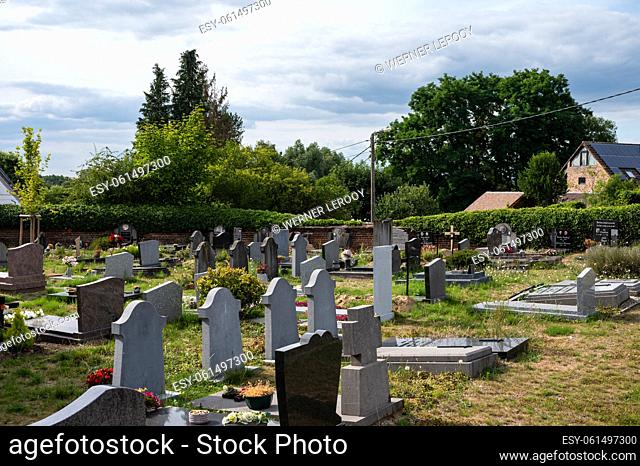 Oud-Heverlee, Flemish Brabant, Belgium - 08 21 2022 - Abandonned grave yard, surrounded with nature