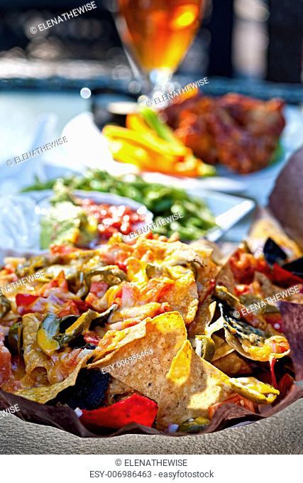 Basket of nachos and other appetizers on restaurant table
