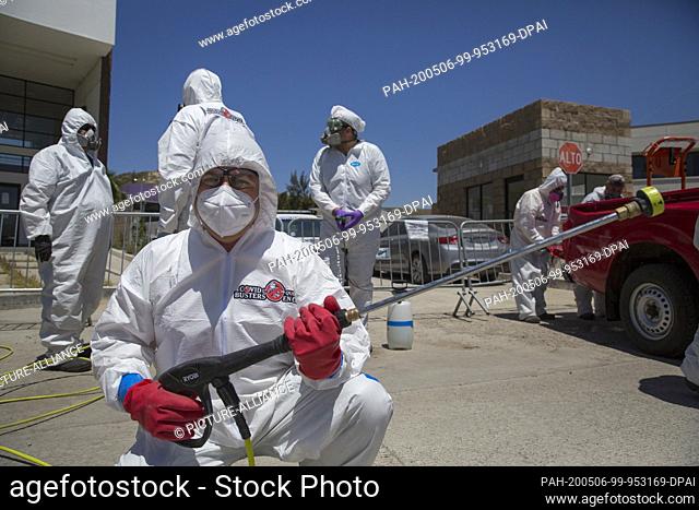 02 May 2020, Mexico, Tijuana: A member of the group ""Covid Busters"" shows disinfectants on the fringes of an action against the spread of Covid-19 The group...