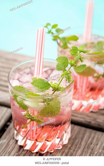 Fresh mineral water with watermelon, sirup and ice in glasses