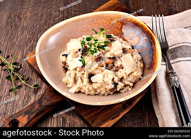 Risotto with porcini mushroom on wooden table