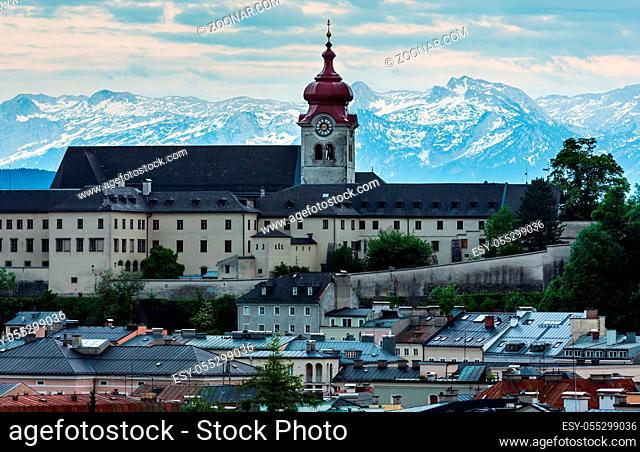 Evening summer Salzburg City (Austria) view from up with Nonnberg Abbey Benedictine monastery (refurbishment in the Baroque style in the 1880s) abd Alps...