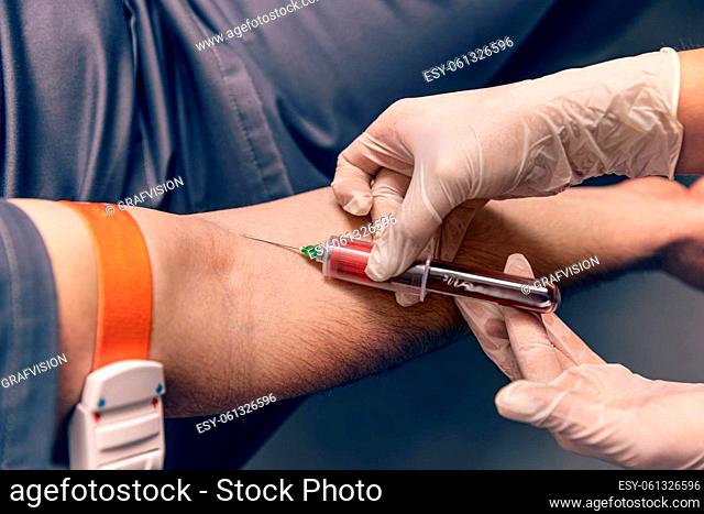 Male patient during blood test sampling procedure