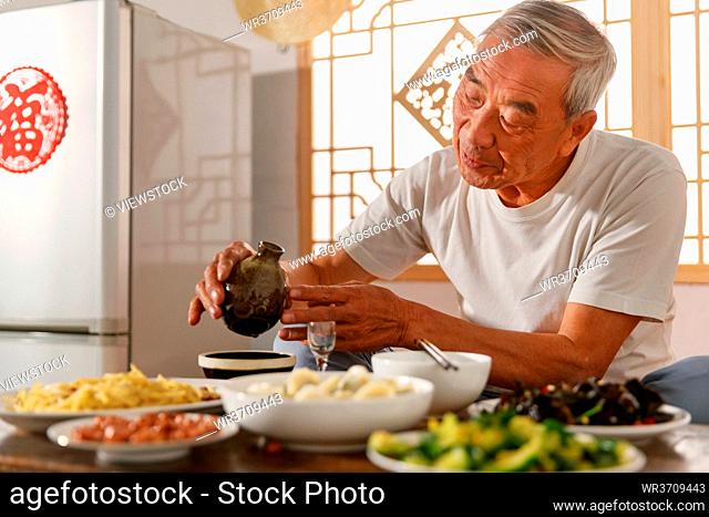 Old people sitting at home eating drinking