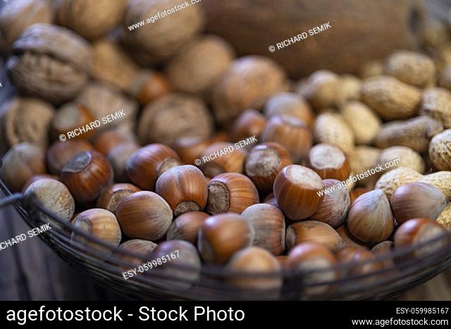 different kinds of nuts on a wooden background