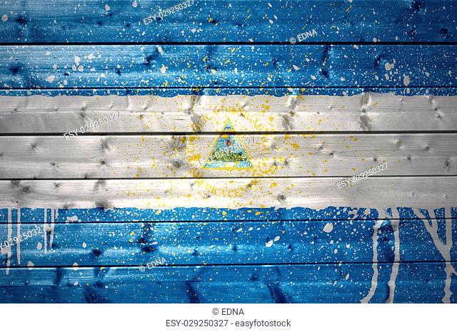 colorful painted nicaraguan flag on a wooden texture