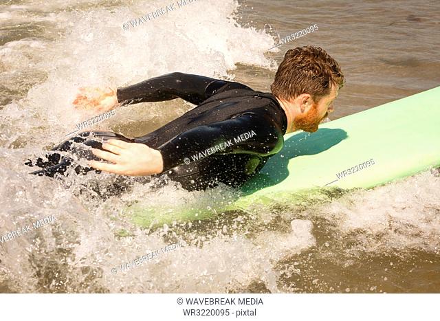 Surfer surfing on seawater
