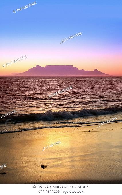 cape town from bloubergstrand at dusk sunset showing lights ocean and beach