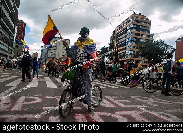 A demonstrator waves a Colombian flag as LGTB+ and Trans communities lead demonstrations as thousands flood the center of Bogota