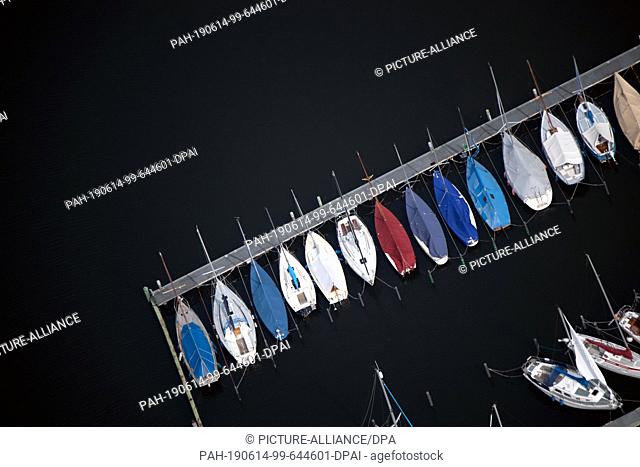 12 June 2019, Berlin: Boats of a club lie at a jetty at Wannsee, recorded with a drone. Photo: Ralf Hirschberger/dpa-Zentralbild/ZB