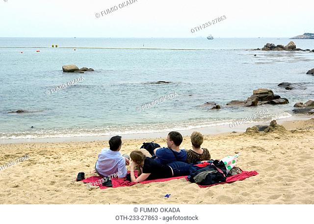 People relaxing at Hung Sing Ye Beach, Lamma Island, Hong Kong