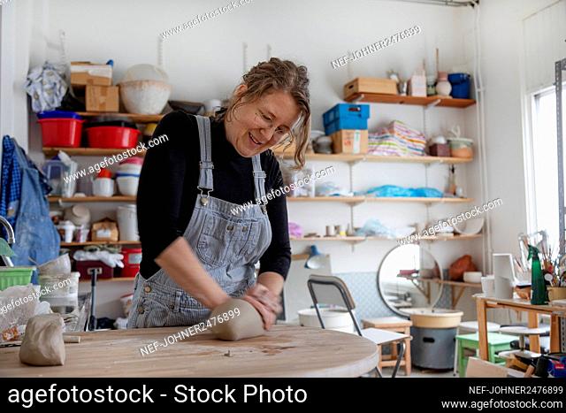 Woman preparing clay in workshop