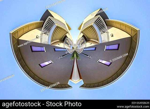 Dual radial bend of an apartment building. Geometric kaleidoscope pattern on mirrored axis of symmetry reflection. Colorful shapes as a wallpaper for...