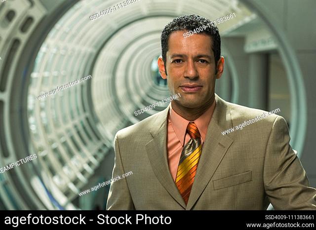 Hispanic businessman in round corridor