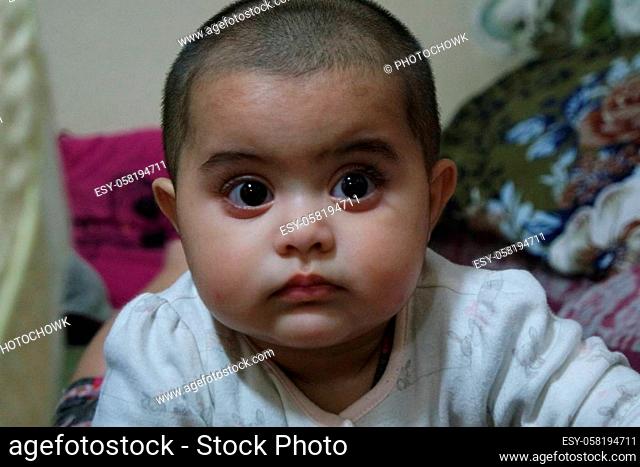 Portrait of a baby girl with smiling face, big eyes and lovely face gesture