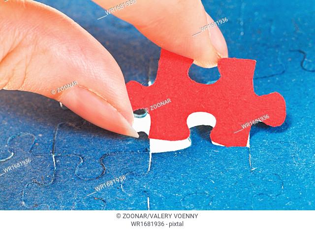 attaching the last red piece of puzzle