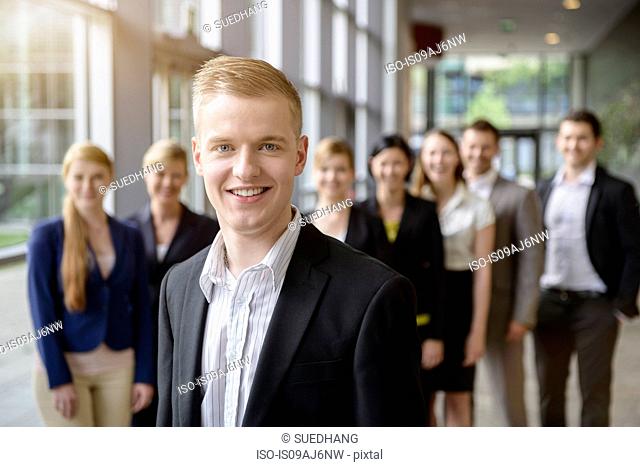 Portrait of businessman and business team standing in a row