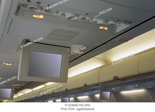 Drop down screens on an aircraft. Television and information monitors for passengers. Inflight entertainment
