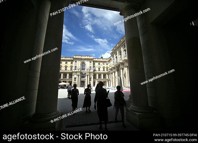 15 July 2021, Berlin: People walk through a portal into the Schlüterhof of the Humboldt Forum. The rebuilt Berlin City Palace opens on July 20 with several...