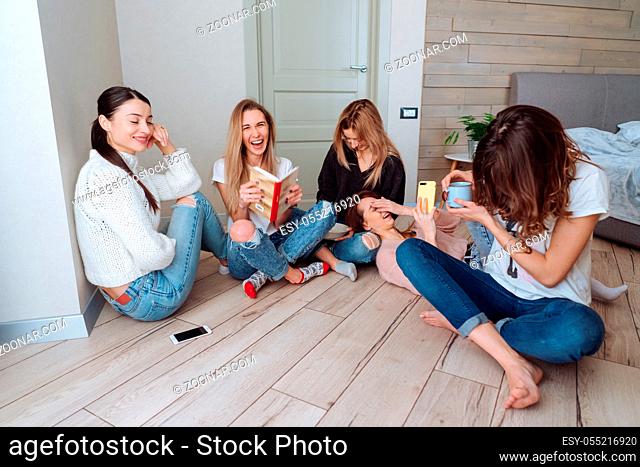 girls on the floor in the apartment have fun