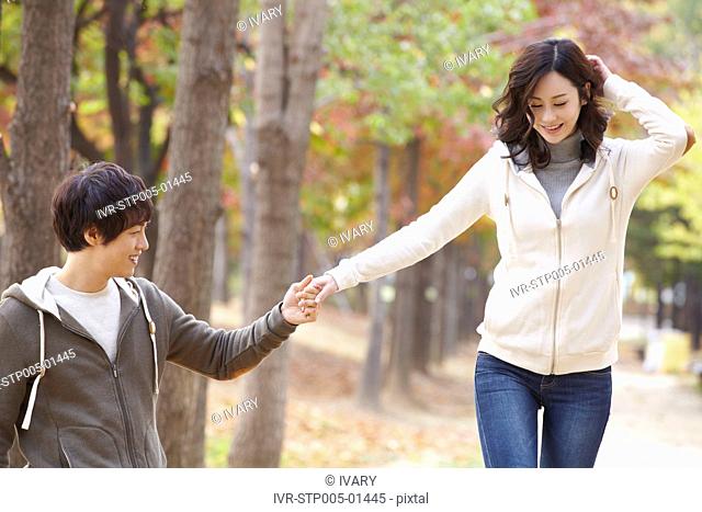 Young Couple In Park In Autumn