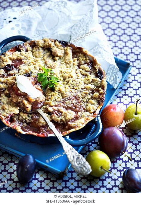 Plum crumble cake in a baking tray