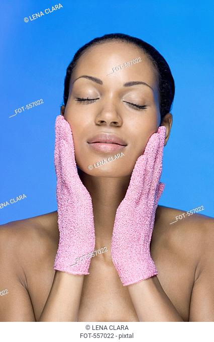 A woman using exfoliation gloves