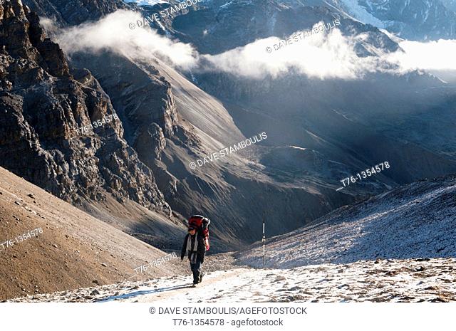 trekker ascending the Thorung La Pass 5416m in the Annapurna region of Nepal
