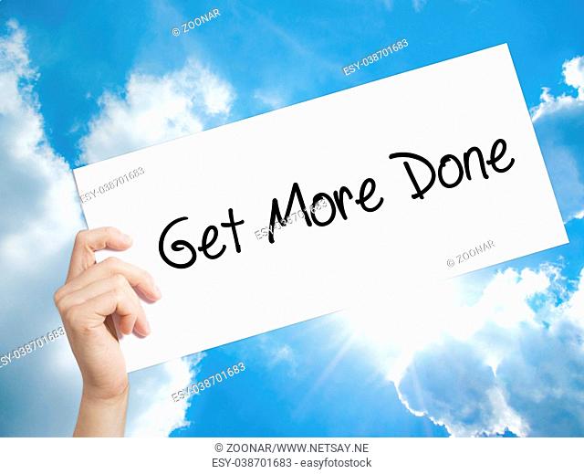 Get More Done Sign on white paper. Man Hand Holding Paper with text. Isolated on sky background