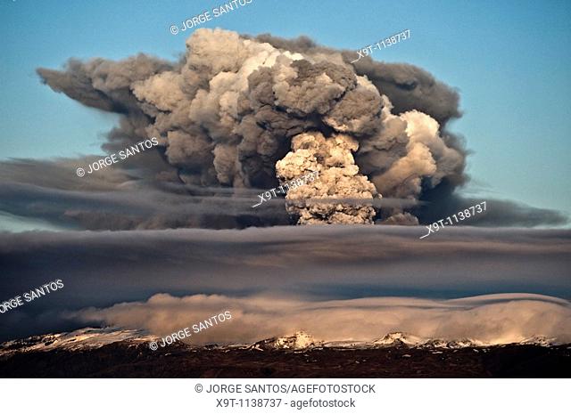 The ash plume of Eyjafjallajökull at sunset shortly after the start of the eruption