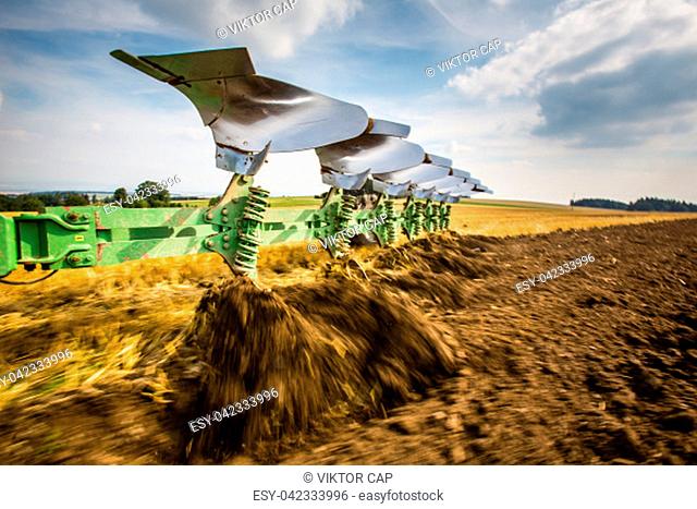 Tractor working on the farm, modern agricultural transport, farmer working in the field, tractor on a sunset background, cultivation of land