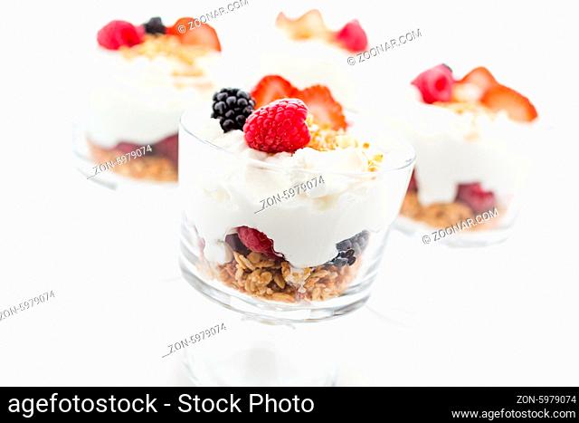 Breakfast parfait made from Greek yogurt and granola topped with fresh berries